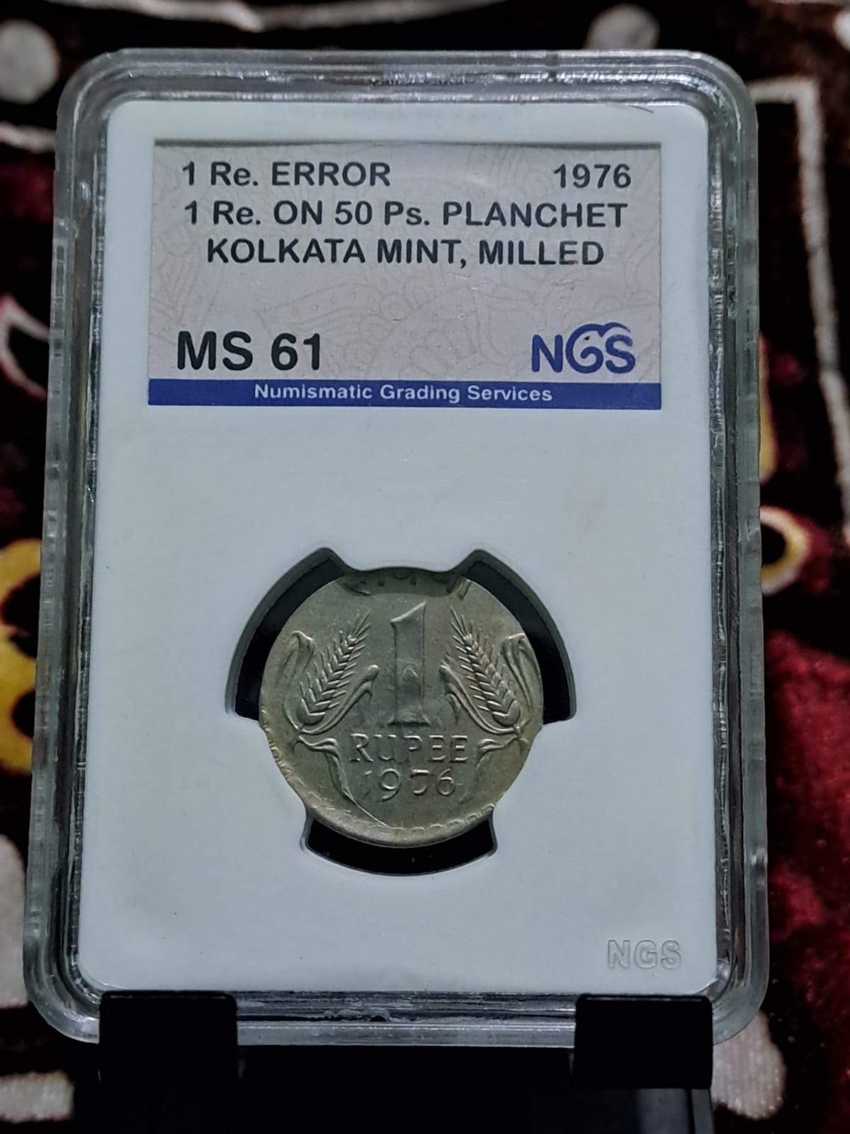 One rupees on 50 paise planchet coin graded